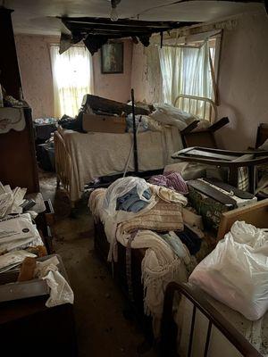Abandoned home clean out, so much moldy trash to pick up in this room. Collapsing ceiling and leaky roof has let water in for a while now