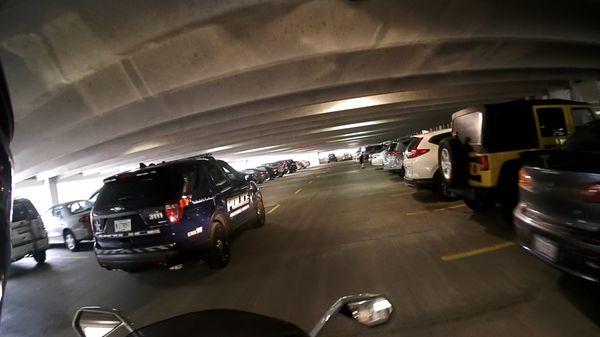 The cops can't even drive on the correct side in this parking garage.