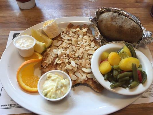 Trout with almonds, baked potato, and veggies.