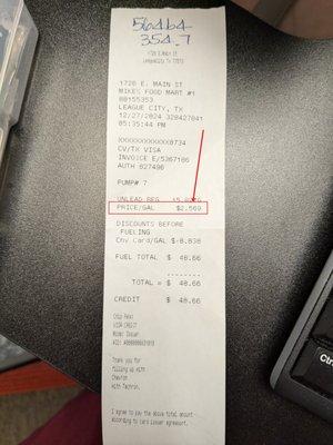 Receipt with price per gallon charged circled.