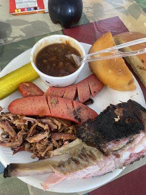 Brisket, ribs, hot links, baked beans, pickle, bun, spicy bbq