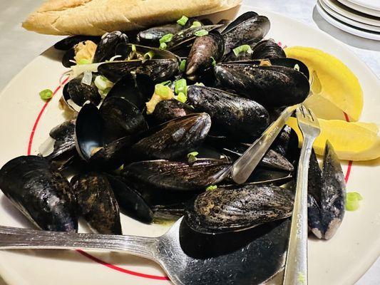Steaming pot of mussels: fresh, savory, and perfect with crusty bread.