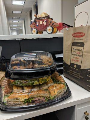 The catered lunch we ordered - lunch tray, salad tray, dessert tray. Chips, pickles, salad dressings, and plates/utensils were in the bag.
