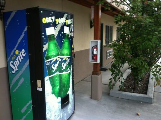 Soda vending machine and fire extinguisher.