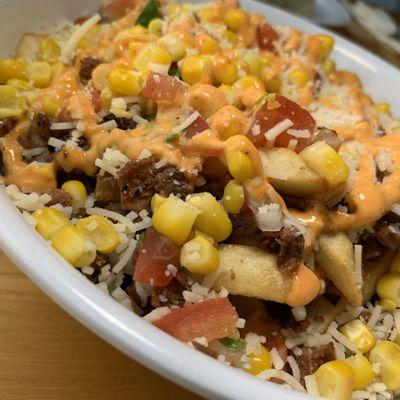 BZ Esquite Fries: French Fries, choice of Protein (Asada), Corn, Pico de Gallo, Vegan Cotija Cheeze, Chipotle Sauce, Salsa (Vegan).