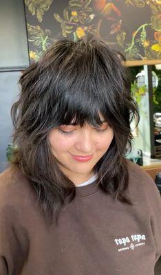 Local musician shyly showing off her fresh, natural-textured shag with bangs.
