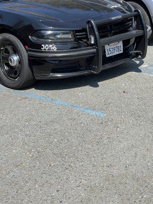 Parked in a painted handicap stall, cars next to it not even parked in a stall.