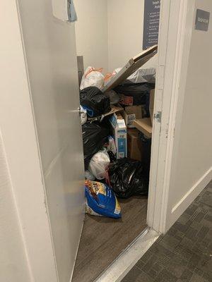 The door to the trash room can't even open all the way because of overflow trash bags