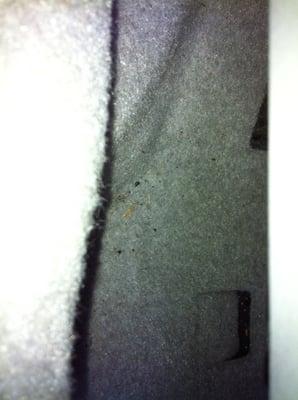 Sand/debris next to the front seat.