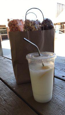A large PinaColada lemonade and three bags of popcorn