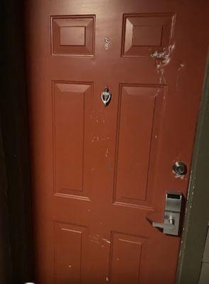 Front door with questionable integrity. Obvious a tool was taken to it especially the keyhole