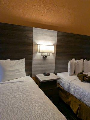 Two queen beds with charging station in the light