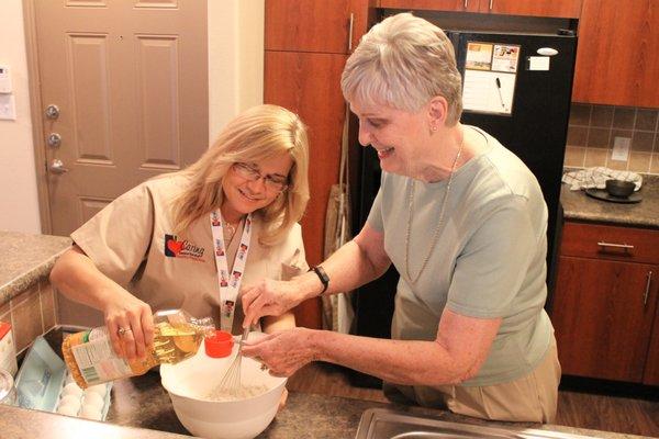Caring Senior Service caregiver baking a cake with a client