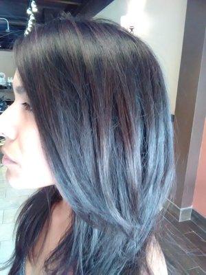 soft natural brown highlights on solid black , long layer
