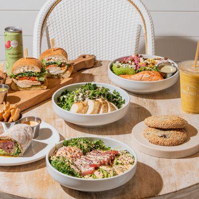 Fresh and healthy table spread featuring vibrant salads, nutritious bowls and wraps, all-day breakfast favorites, superfood s...