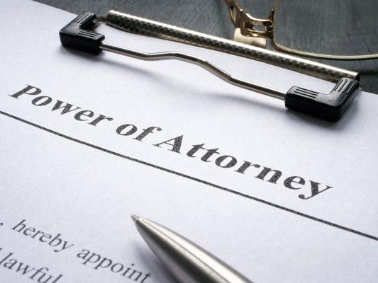 power of attorney document on clipboard
