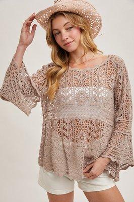 The crocheted sheer bell-sleeve pullover top is a charming and feminine garment with intricate crochet detailing, creating a sheer and airy