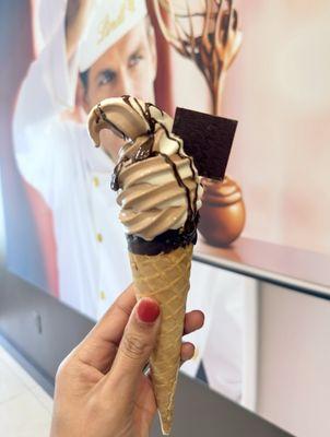 Swirl ice cream cone with hazelnut drizzle