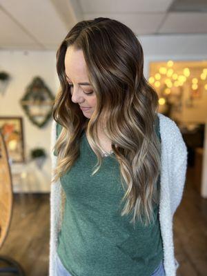 Low-maintenance hair color refers to a coloring technique or shade that requires minimal upkeep over time.