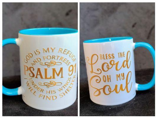 A vibrant White Cup filled with blue. Gold lettering God is my refuge and fortress Psalm 91 Bible Verse