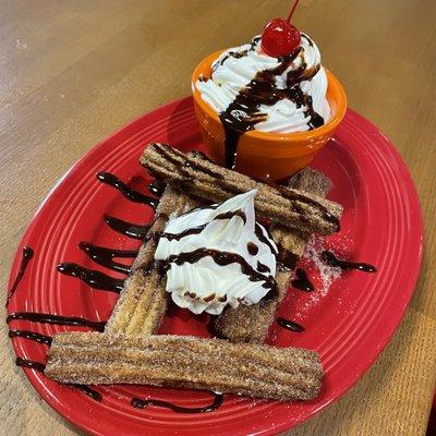 Churros come with ice cream smothered in whipped cream