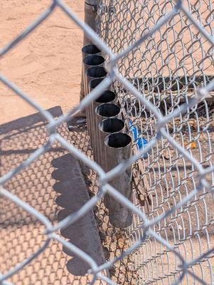 Tubes for bats in the dugout by Softball Field #2