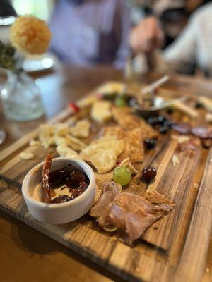Half eaten large Charcuterie board--plenty for 8 to share.