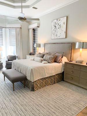 Luxe bedroom design includes a custom made headboard that is perfectly coordinated with the custom bed treatment.