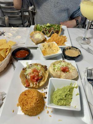 Puffy tacos with side of rice and guacamole