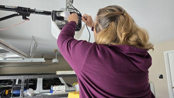Wiring and programming a smart garage door opener during a service call in Edwardsville, IL.