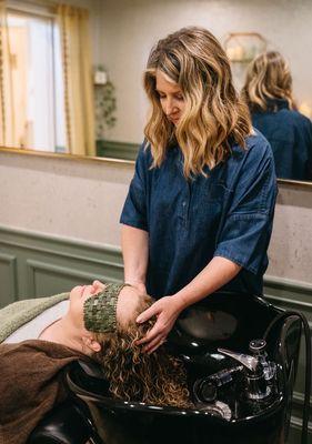 Amy providing healing reiki during a scalp treatment.