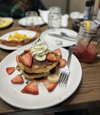 Strawberry cream cheese pancakes with a side of Baked Bacon, scrambled eggs and Strawberry Lemonade Spritzer