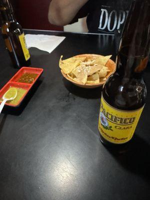 Chips and salsa with a Pacifico on the side