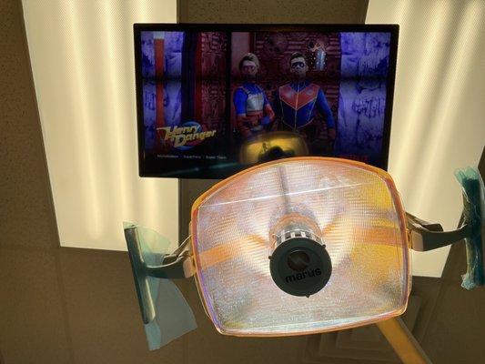 In the dentist chair watching a movie.