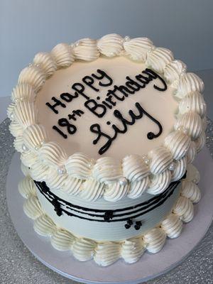 Elegant and timeless--a white vintage cake adorned with musical notes throughout, perfect for the music lover's celebration. #MusicCake