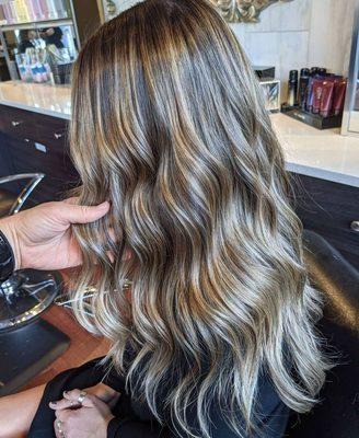 This free-hand balayage technique has added dimension and depth to the client's natural hair color, creating a beautiful and modern look.