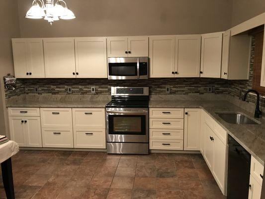 Cream shaker cabinets with stone done by Kern Marble and Granite.