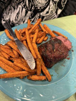 Wagyu steak with sweet potato fries and a salad.