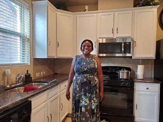 Satisfied costumer after her cupboards got repainted by All In One Maintenance