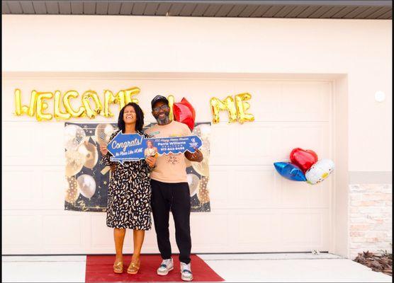 Happy homeowners celebrating a closing with Parris Williams at Coldwell Banker Richwill Realty.