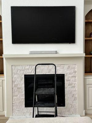 Frame TV above fireplace.