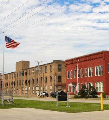 Outside Clack Logic's main office (red building on the right) and one of our warehouses (tan building pictured on the left).