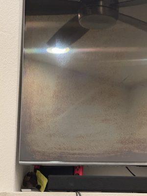 You can clearly see where they wiped it, as the corner was the original color of the screen.