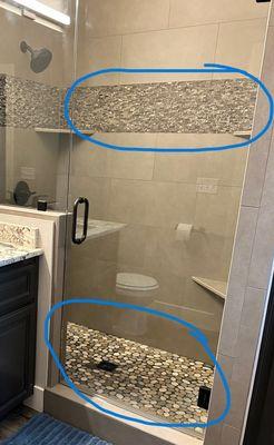 Completed shower with incorrected pebbles in the pan. Should be the same tones as the accent tile on top.