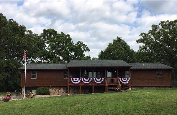 Look for the big Cedar house on the corner of O Highway and Aqua Vita Road.