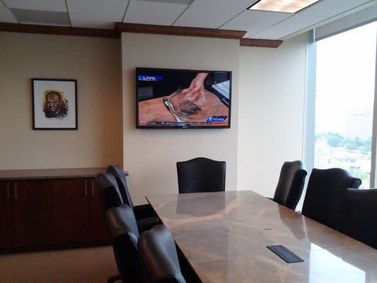 Conference HDTV installation with HDMI cable for laptops at the Conference Table, Hidden AV stack and Harmony remote controls.