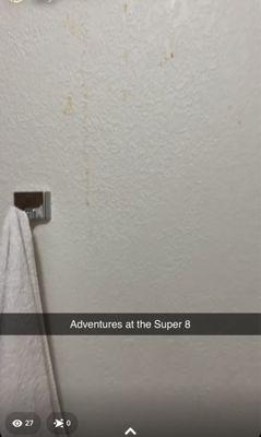 Towel that is NOT ours and something yellow dripping on walls in bathroom.