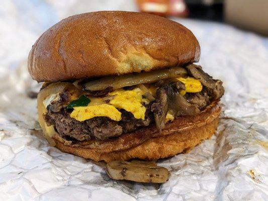 My custom burger today from Flat Iron Grill. I got it with American cheese, sauteed mushrooms and onions, and a fried egg.