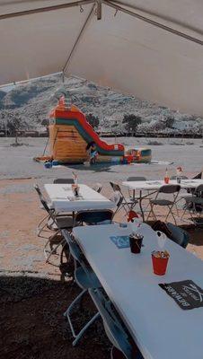 Water slide + tables, tent, and chairs.