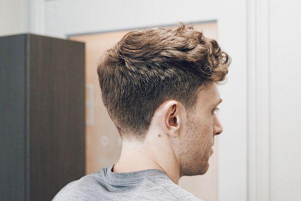 Low tapered haircut with curly textured top